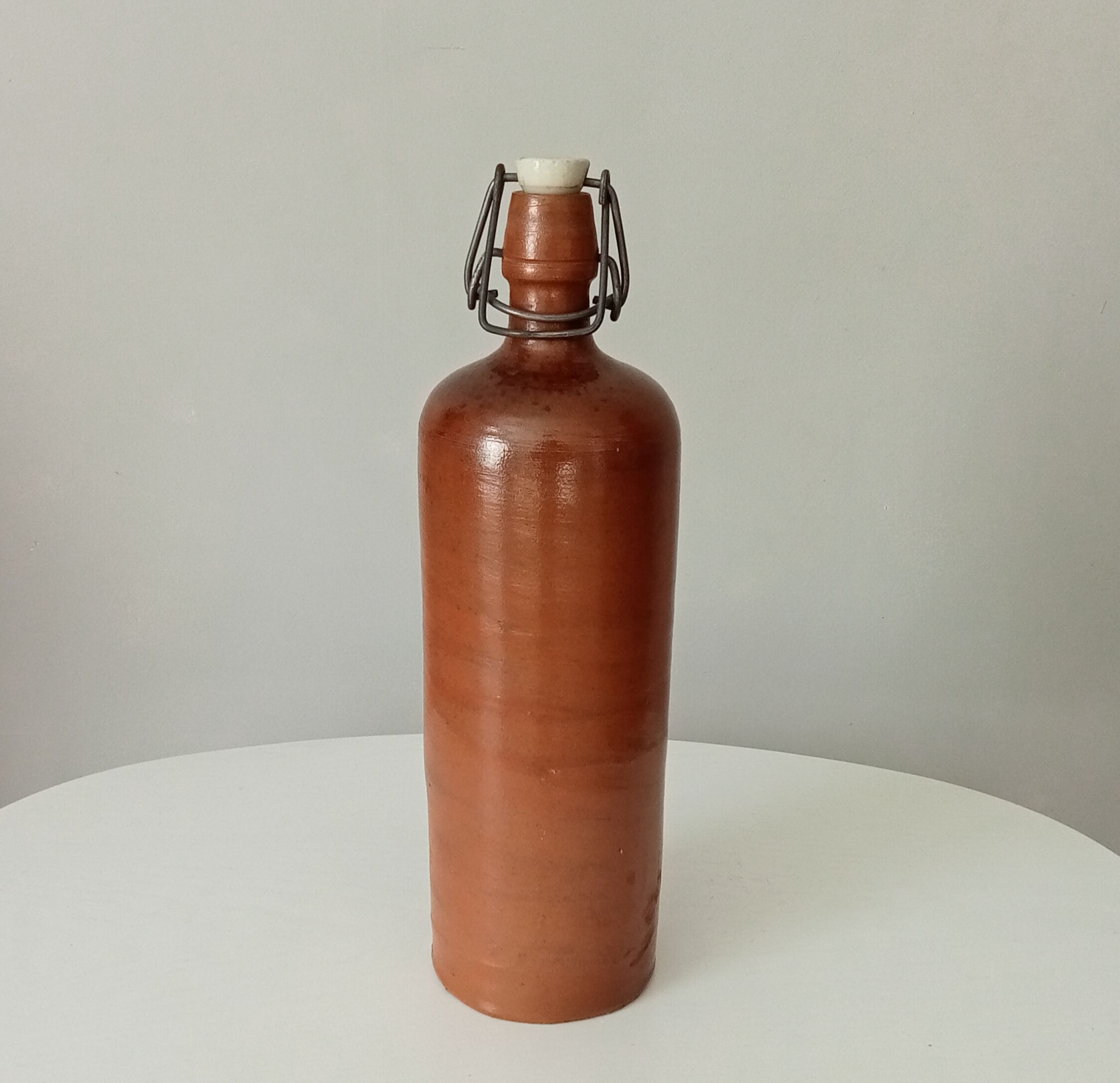 Old bottle in glazed sandstone
