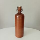 Old bottle in glazed sandstone