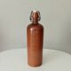 Old bottle in glazed sandstone