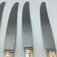 12 silver metal knives.