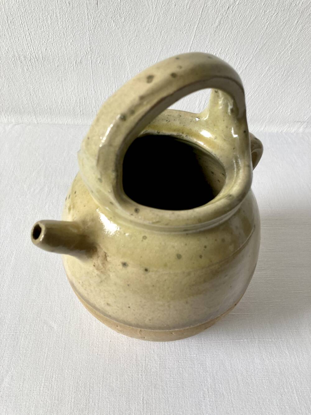 Old small goat-shaped jug in ochre glazed stoneware.
