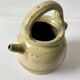 Old small goat-shaped jug in ochre glazed stoneware.