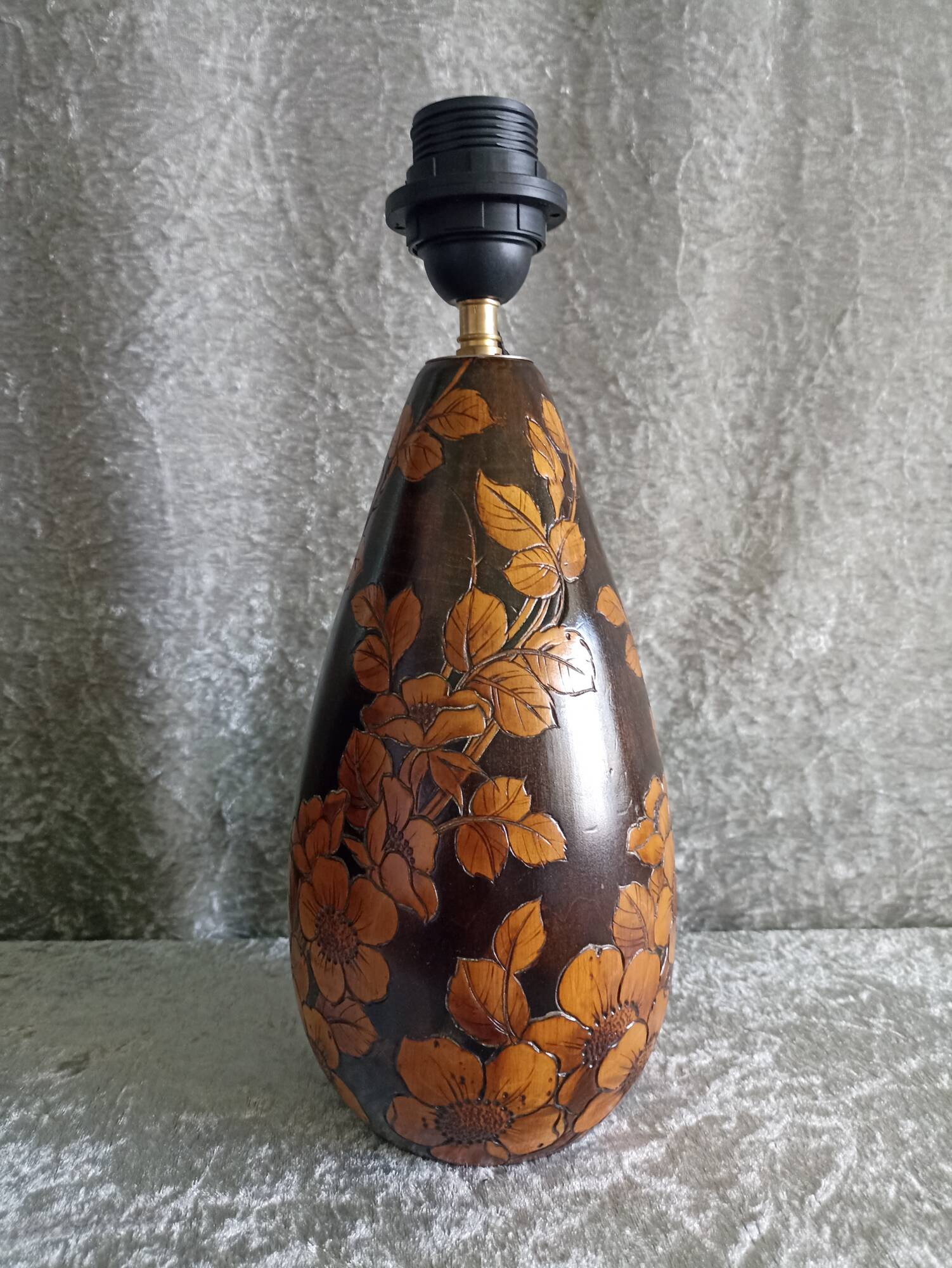 Carved wooden lamp with floral motif