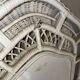 Vintage white rattan mirror with a gothic frame.