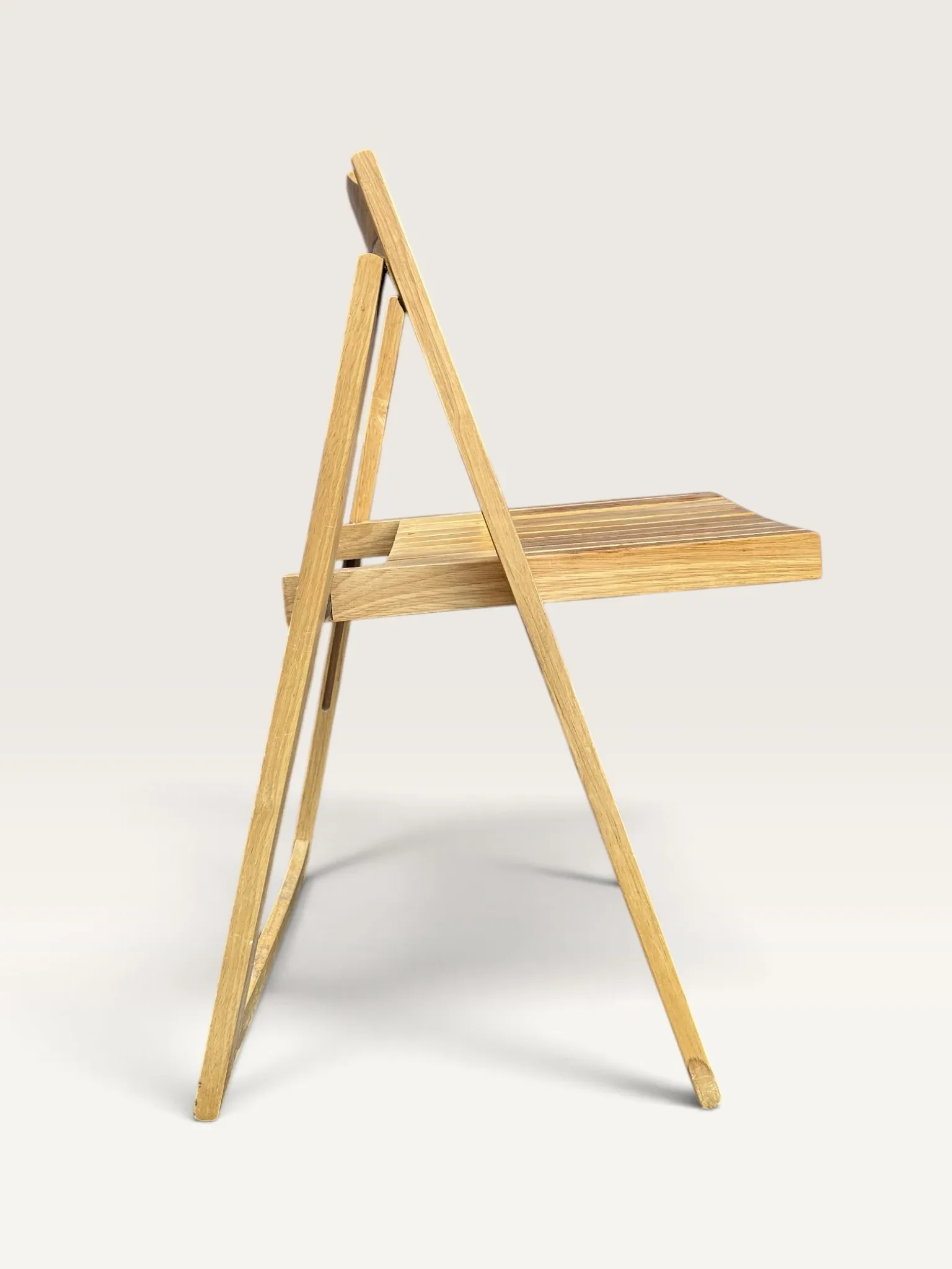 Blonde wooden folding chair in the style of Aldo Jacober.
