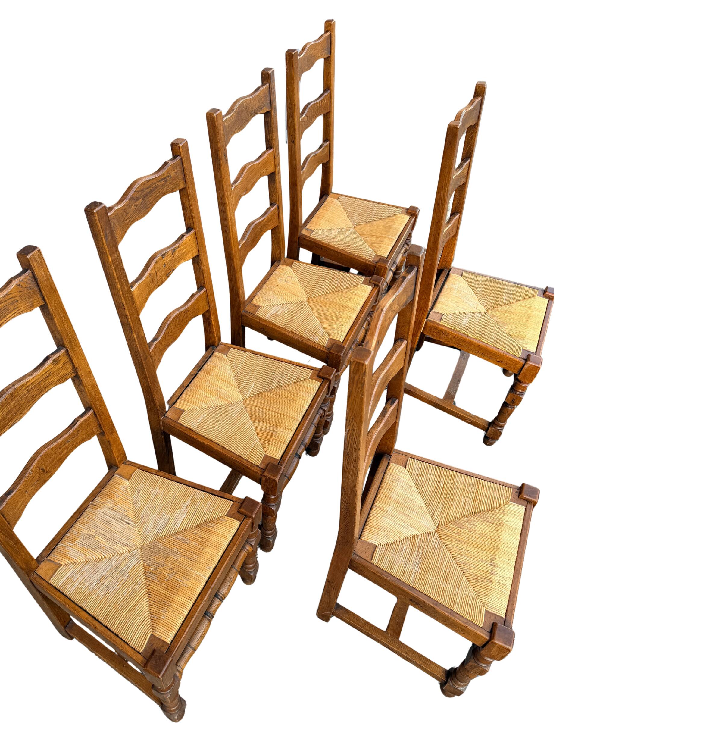 Set of 6 solid wood chairs with straw seats.