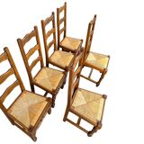 Set of 6 solid wood chairs with straw seats.