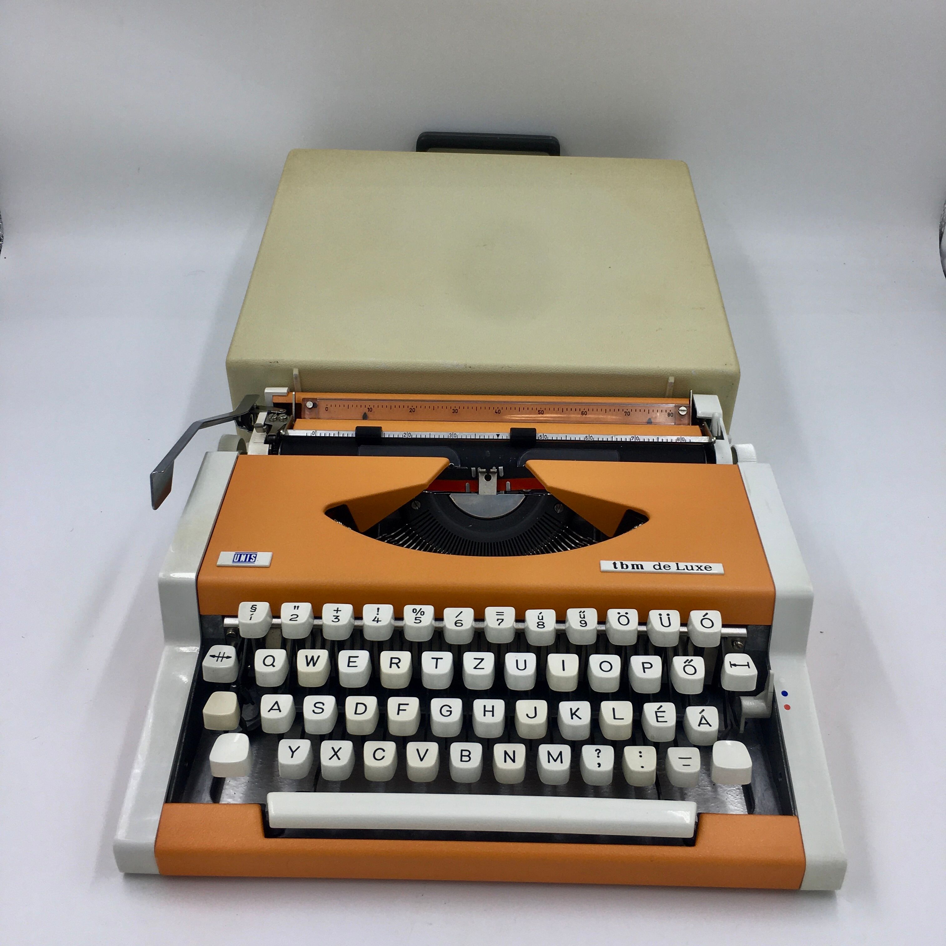 WE typewriter orange