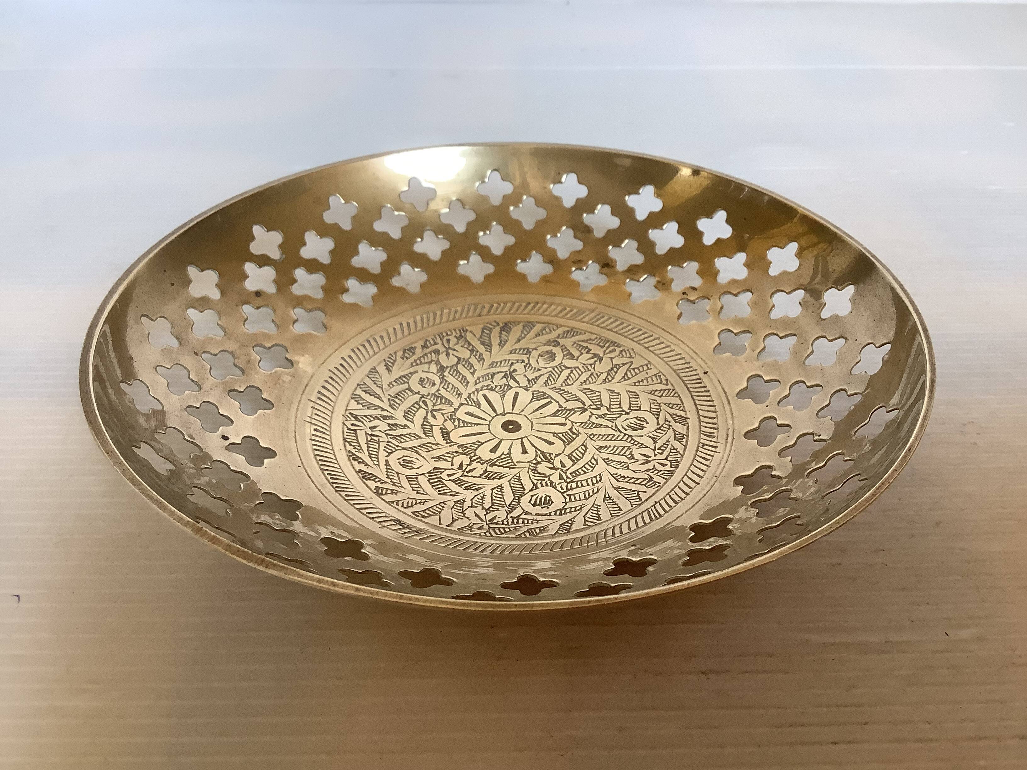 Lattice brass catchall and candlestick.