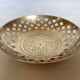 Lattice brass catchall and candlestick.