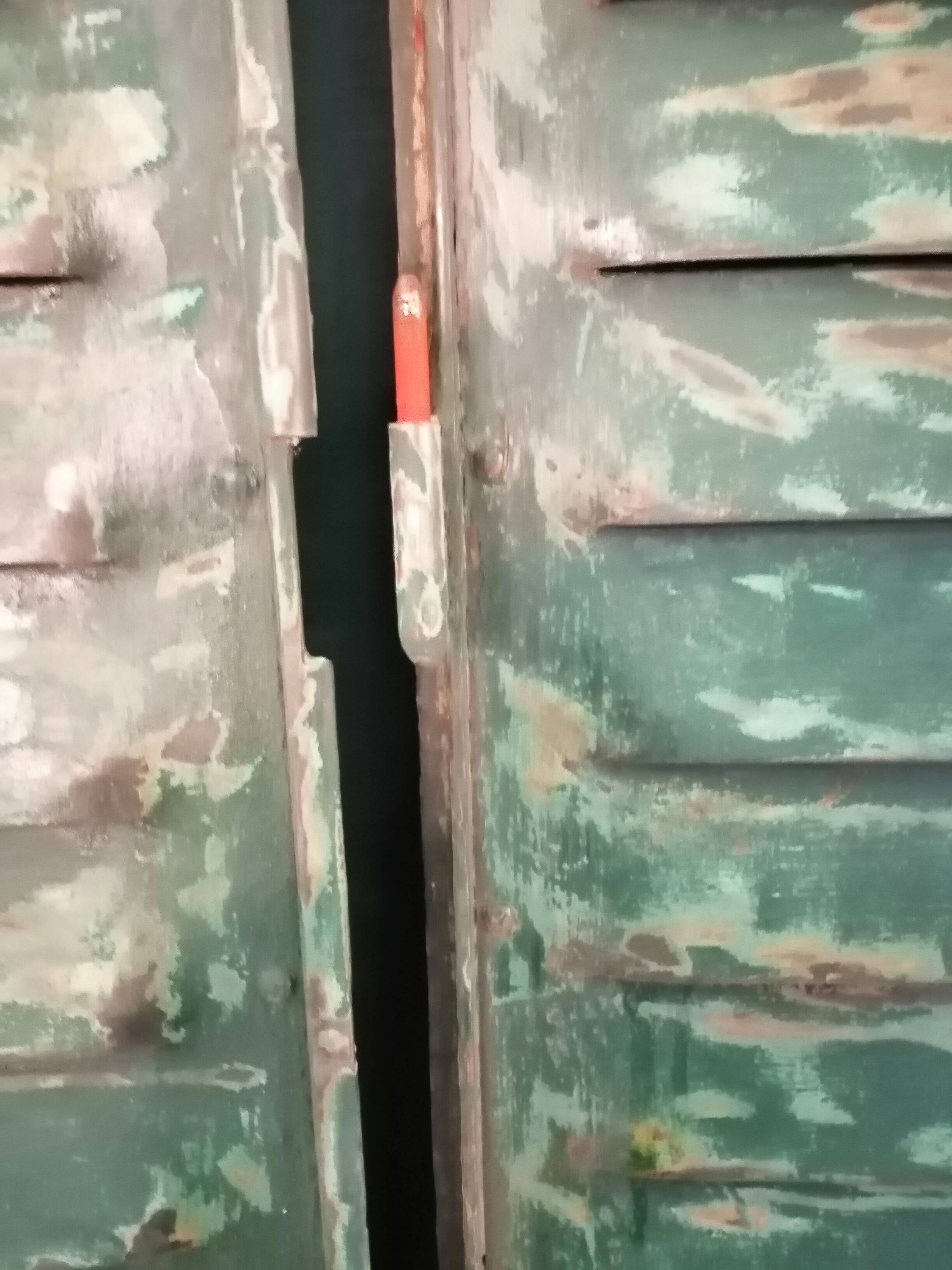 Lot of old green shutters in 4-part iron screen headboard