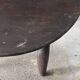 Antique round coffee table in Indonesian teak with turned legs.