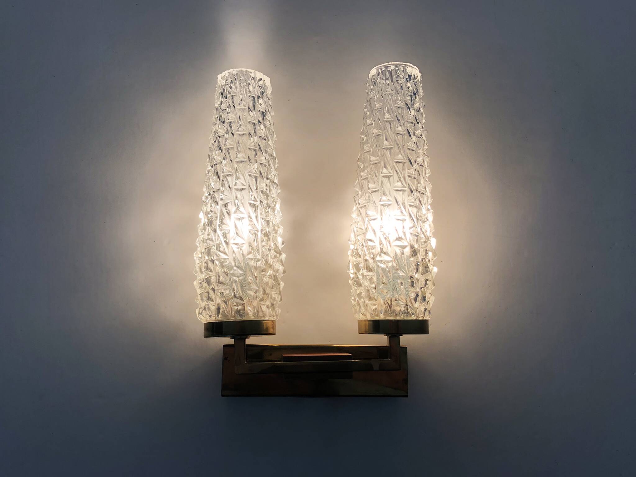 Pair of double-light wall lights, brass, teak globe, glass tubes. 50s-60s