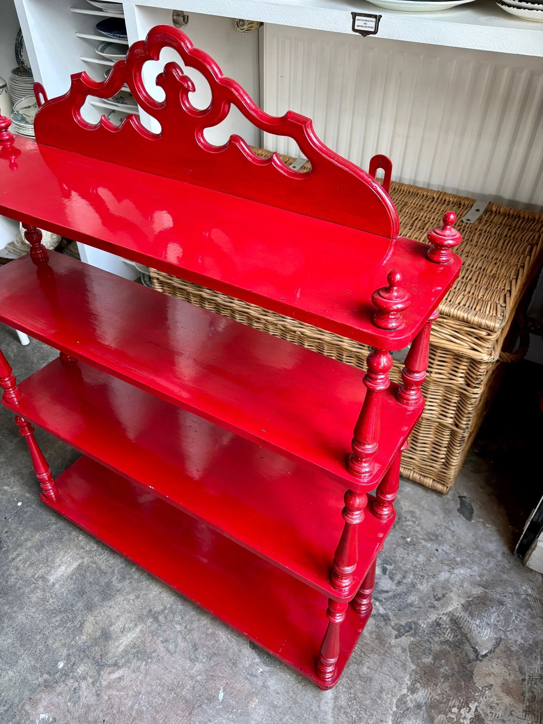 Wall shelf with 4 red lacquered wooden shelves.