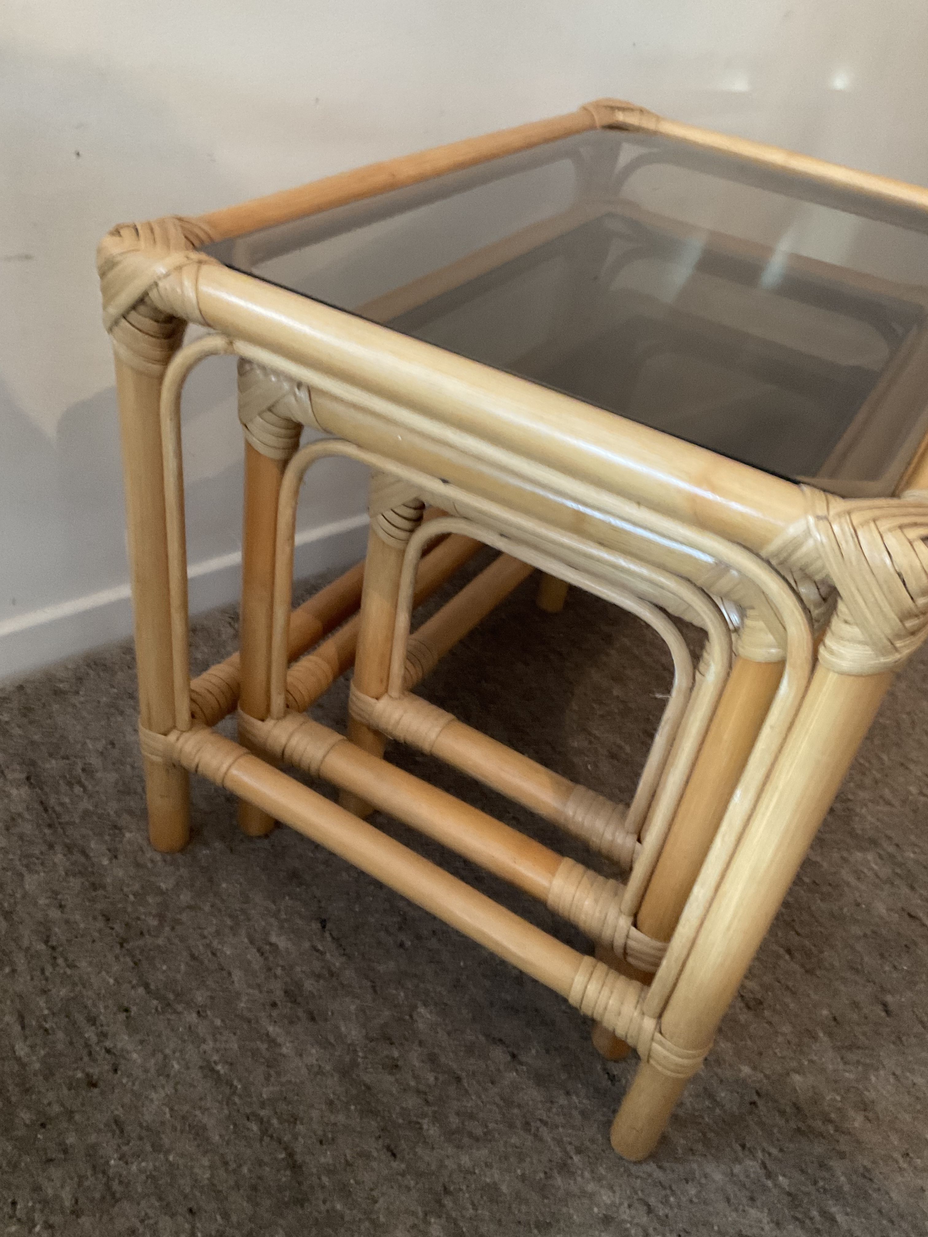 Trio of vintage pull-out tables in rattan and smoked glass 70s