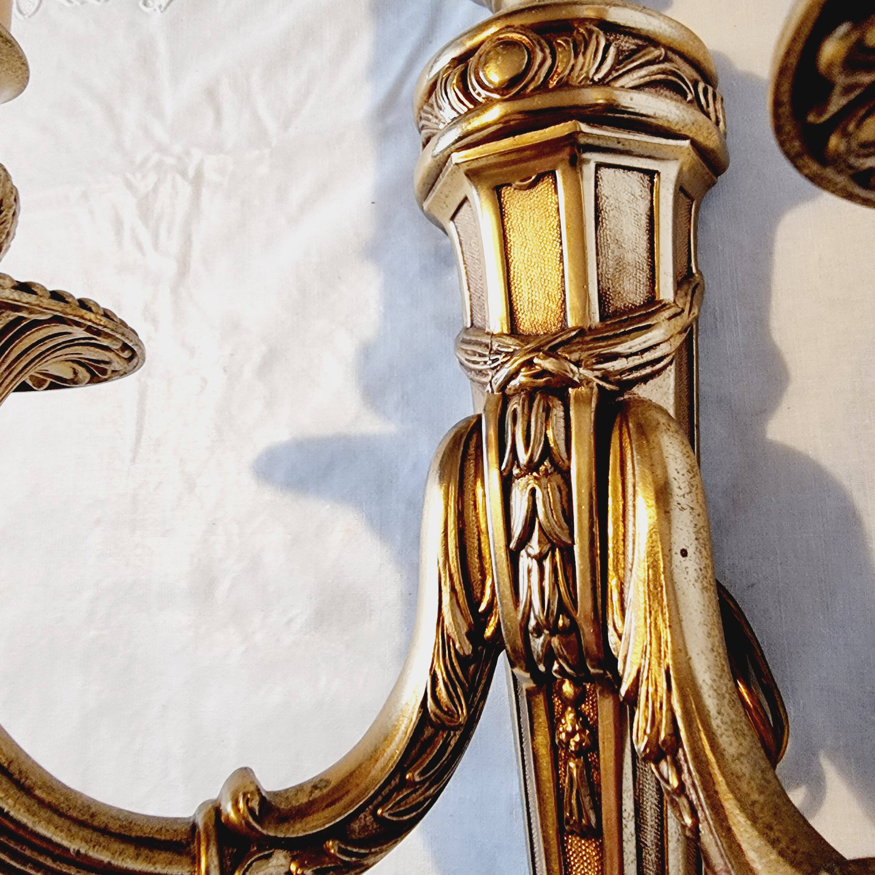 Pair of Louis XV style rocaille two-armed sconces in gilded bronze