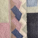 Hand-knotted wool rug by Tisca with a geometric pattern, signed "ILES", France, 1990s.