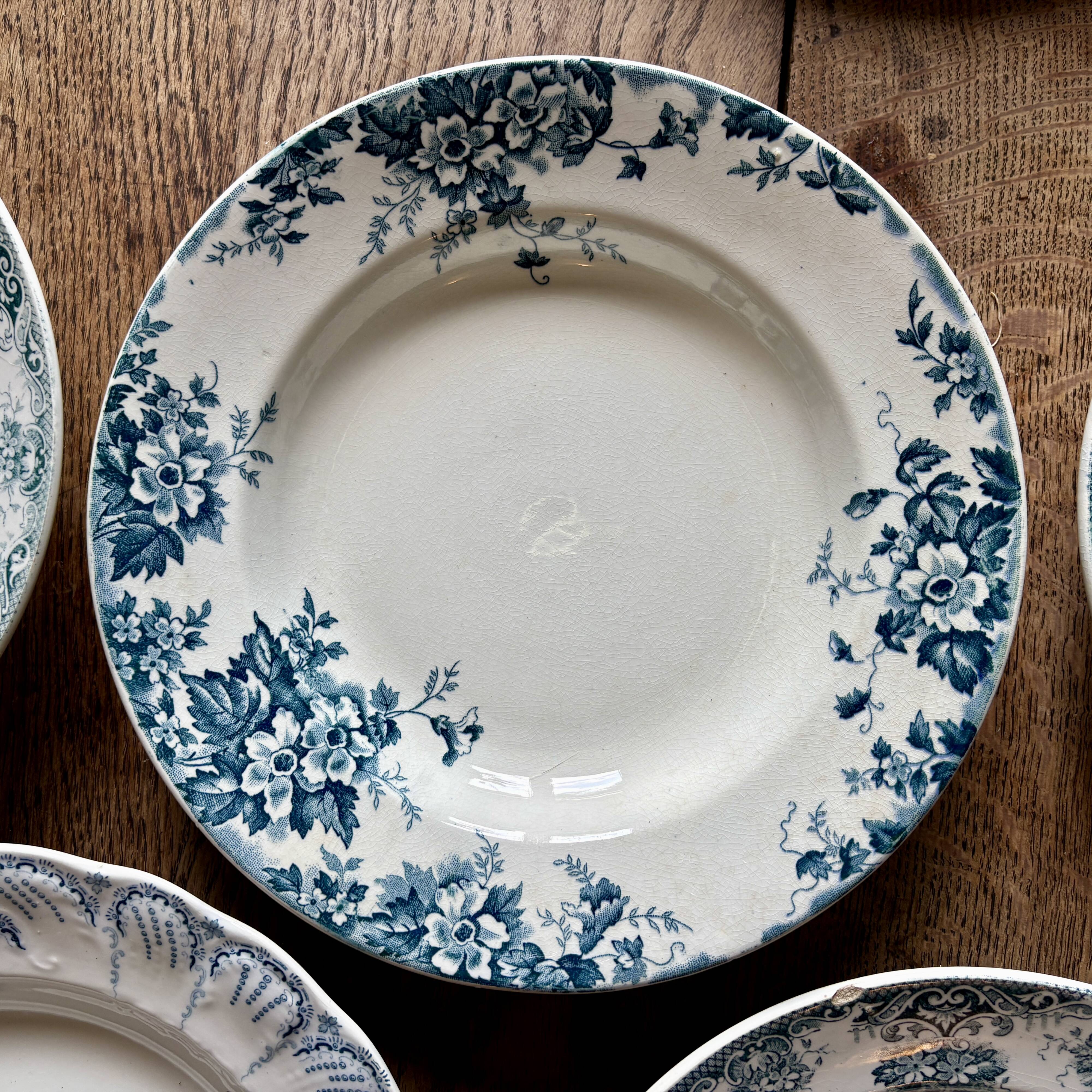 Set of 8 mismatched antique ironstone deep plates.