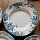 Set of 8 mismatched antique ironstone deep plates.
