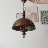 Rustic old wooden and brass suspension.