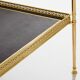Pair of neoclassical side tables in brass and black leather by Maison Jansen, 1960.