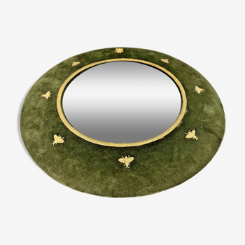 Round witch mirror framed in green velvet