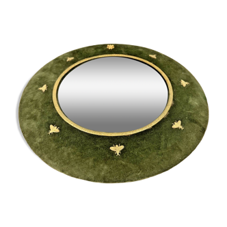 Round witch mirror framed in green velvet