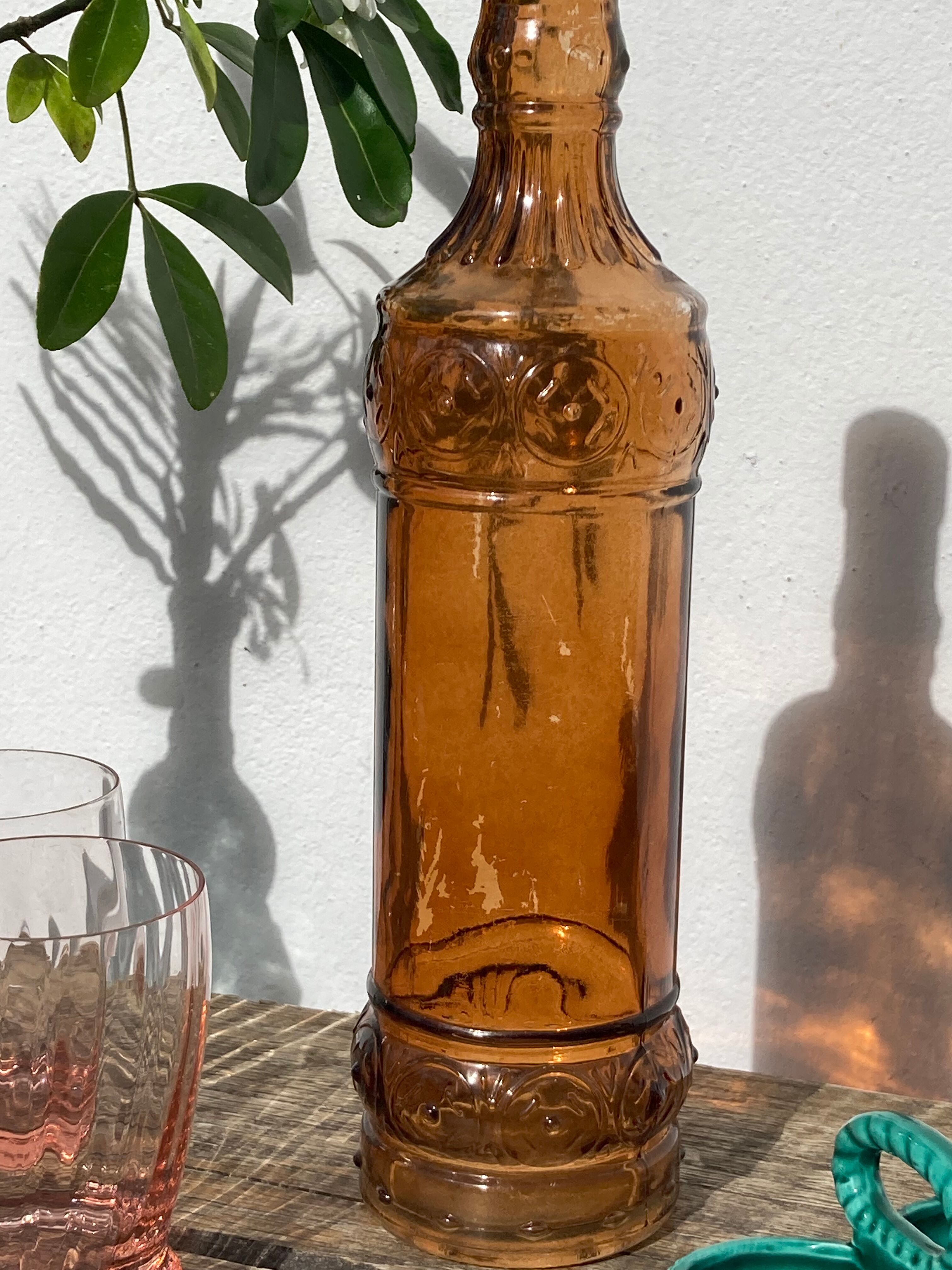 Vintage amber bottle in patterned brown glass