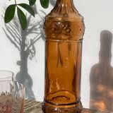 Vintage amber bottle in patterned brown glass