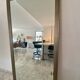 Textured embossed metal wall mirror with bevelled mirror.