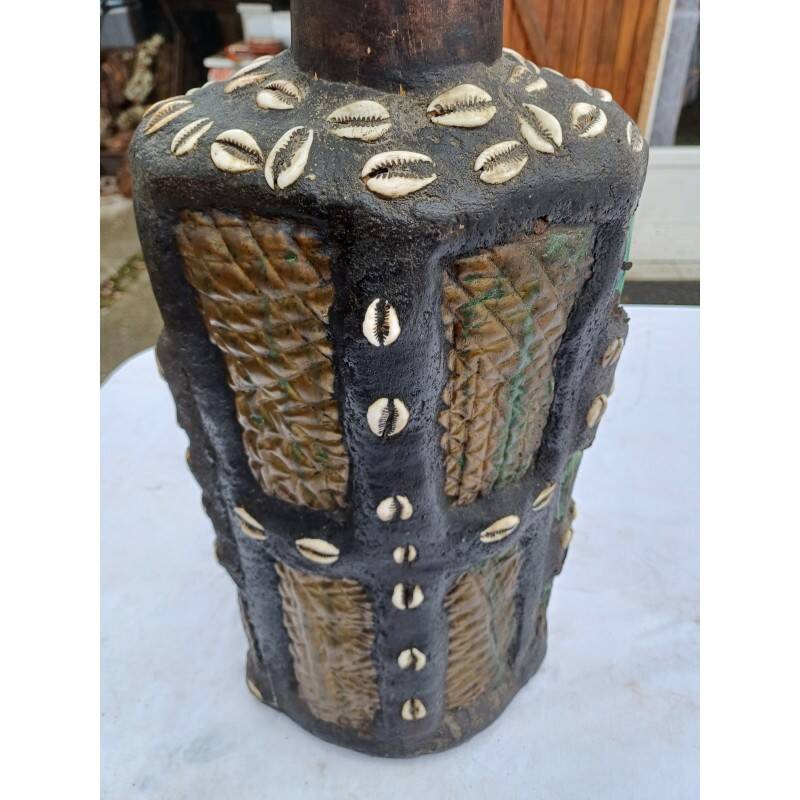 African statue of a woman, made of wood, brass, beads, and seashells.