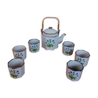 Enamelled sandstone tea service decorated with blue flowers, teapot and six cups