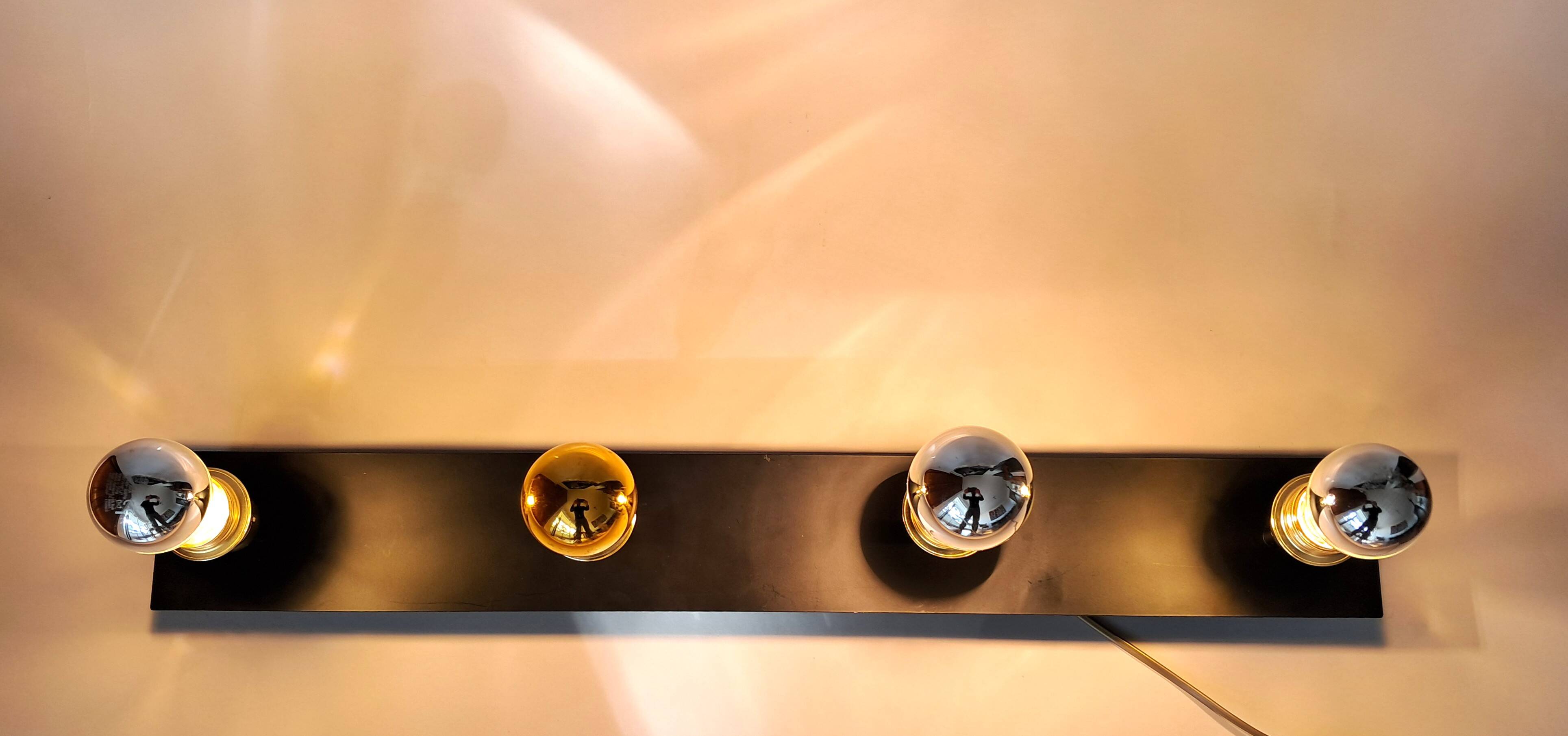 Wall lamp with 4 adjustable lights in black metal and gold-plated brass sockets.