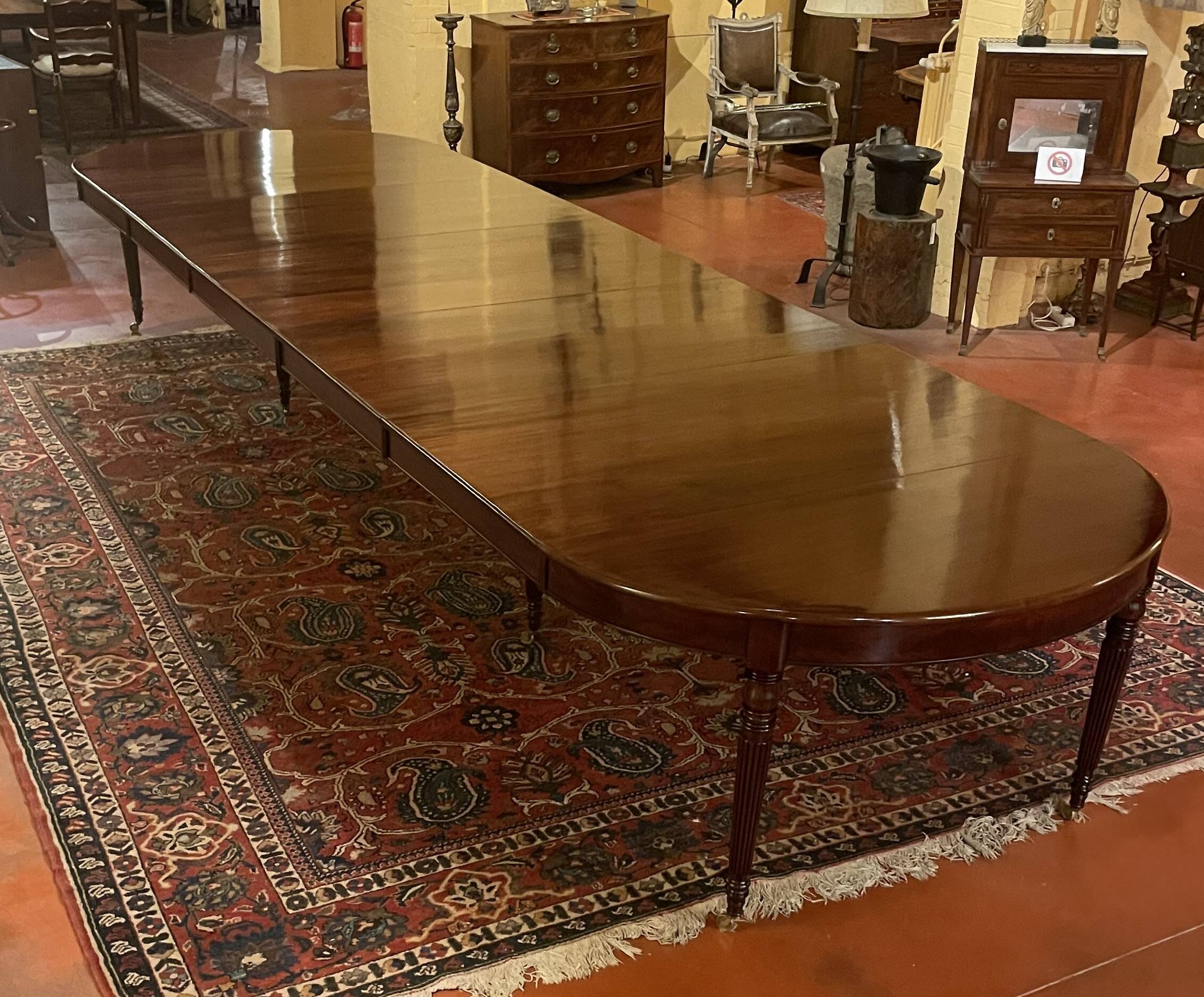 Extensible dining table from the Louis XVI period in mahogany with a banded top.