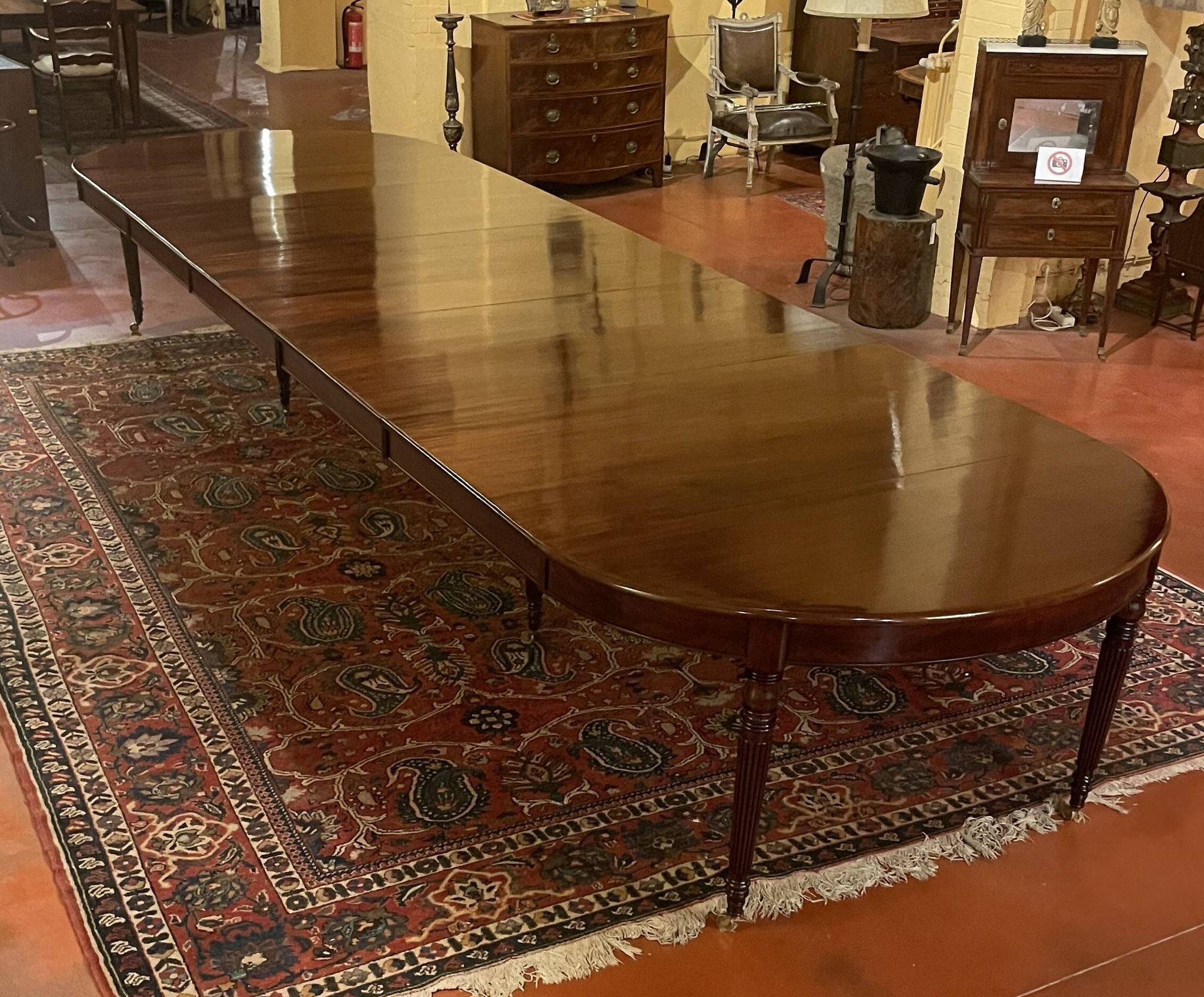 Extensible dining table from the Louis XVI period in mahogany with a banded top.