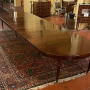 Extensible dining table from the Louis XVI period in mahogany with a banded top.