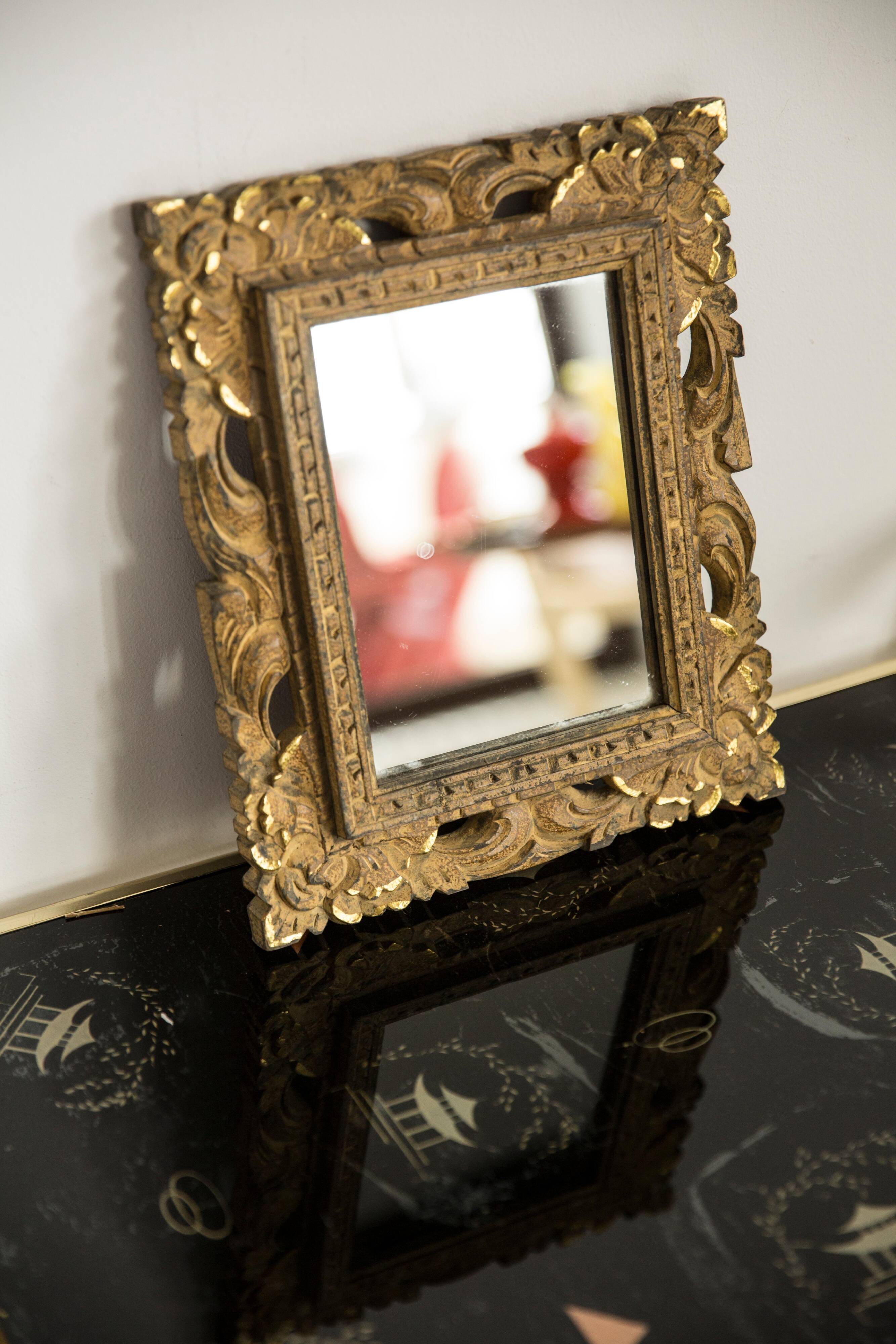 Decorative gold mirror mid-century in a wooden frame, Italy, 1960s.