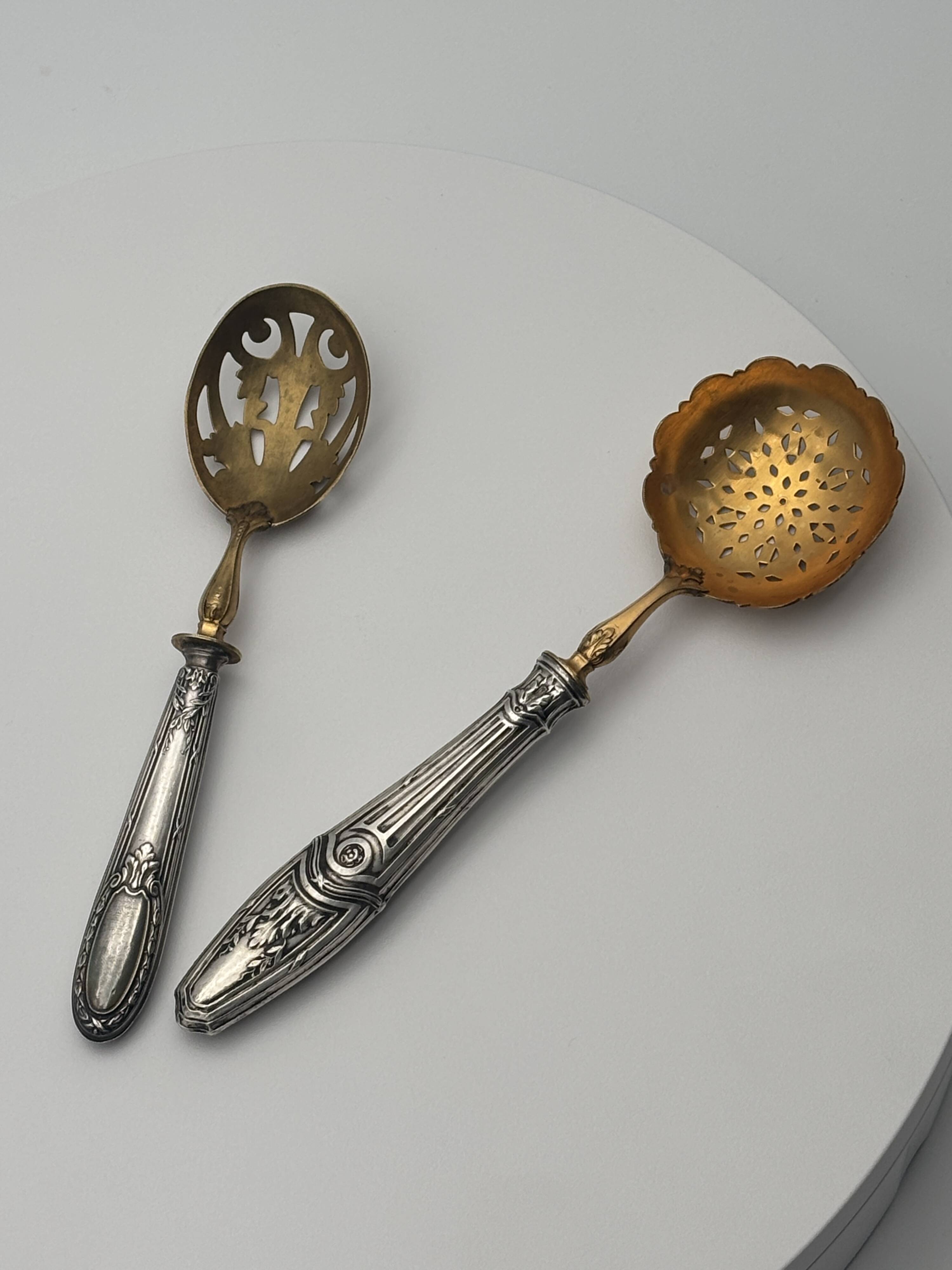 Pair of silver Minerva and vermeil shakers, 19th century.