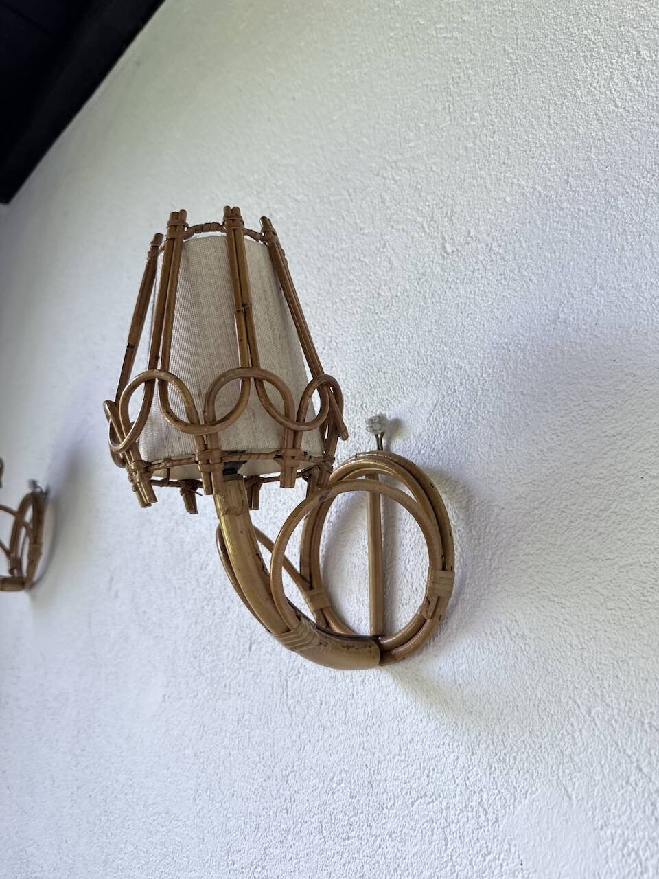 Pair of rattan wall lights by Louis Sognot, 1960.