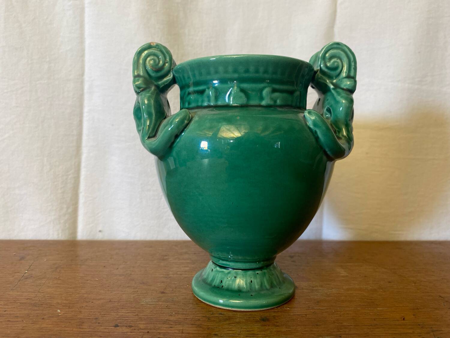Antique green ceramic vase with handles