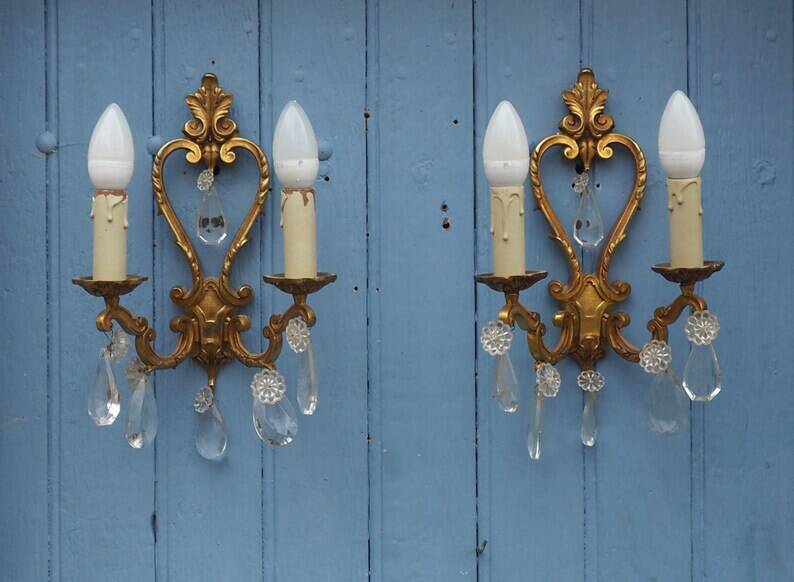French antique Louis XV style twin arm wall sconces in bronze with crystals.