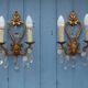 French antique Louis XV style twin arm wall sconces in bronze with crystals.