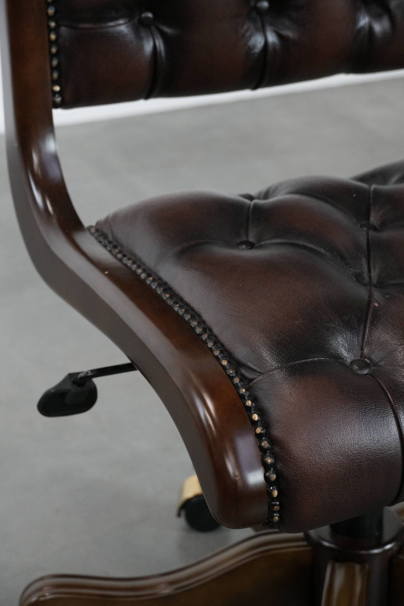 Chesterfield office chair in English style made of cow leather and wood.
