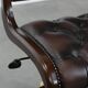 Chesterfield office chair in English style made of cow leather and wood.