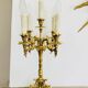 Massive gilded bronze chandeliers from the mid-20th century with marble bases.