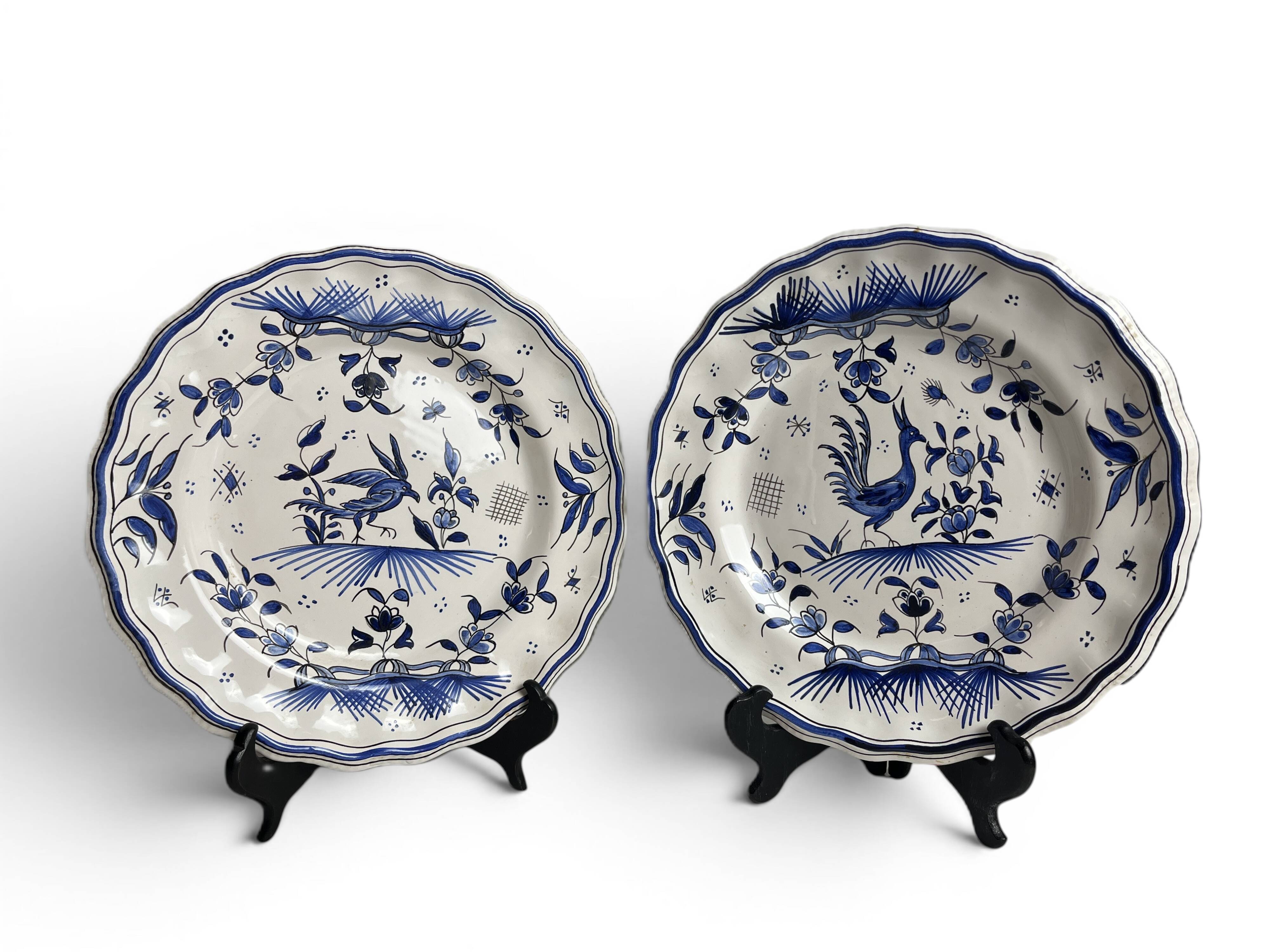 Moustiers, pairs of plates with wading bird design, scalloped edge, early 20th century.