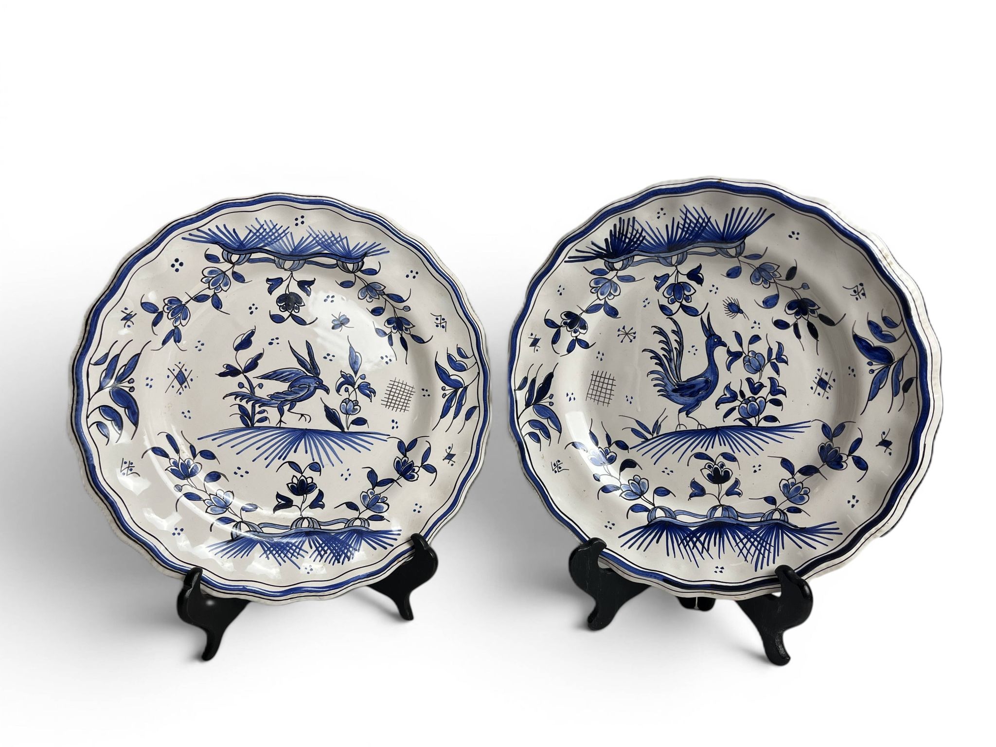 Moustiers, pairs of plates with wading bird design, scalloped edge, early 20th century.