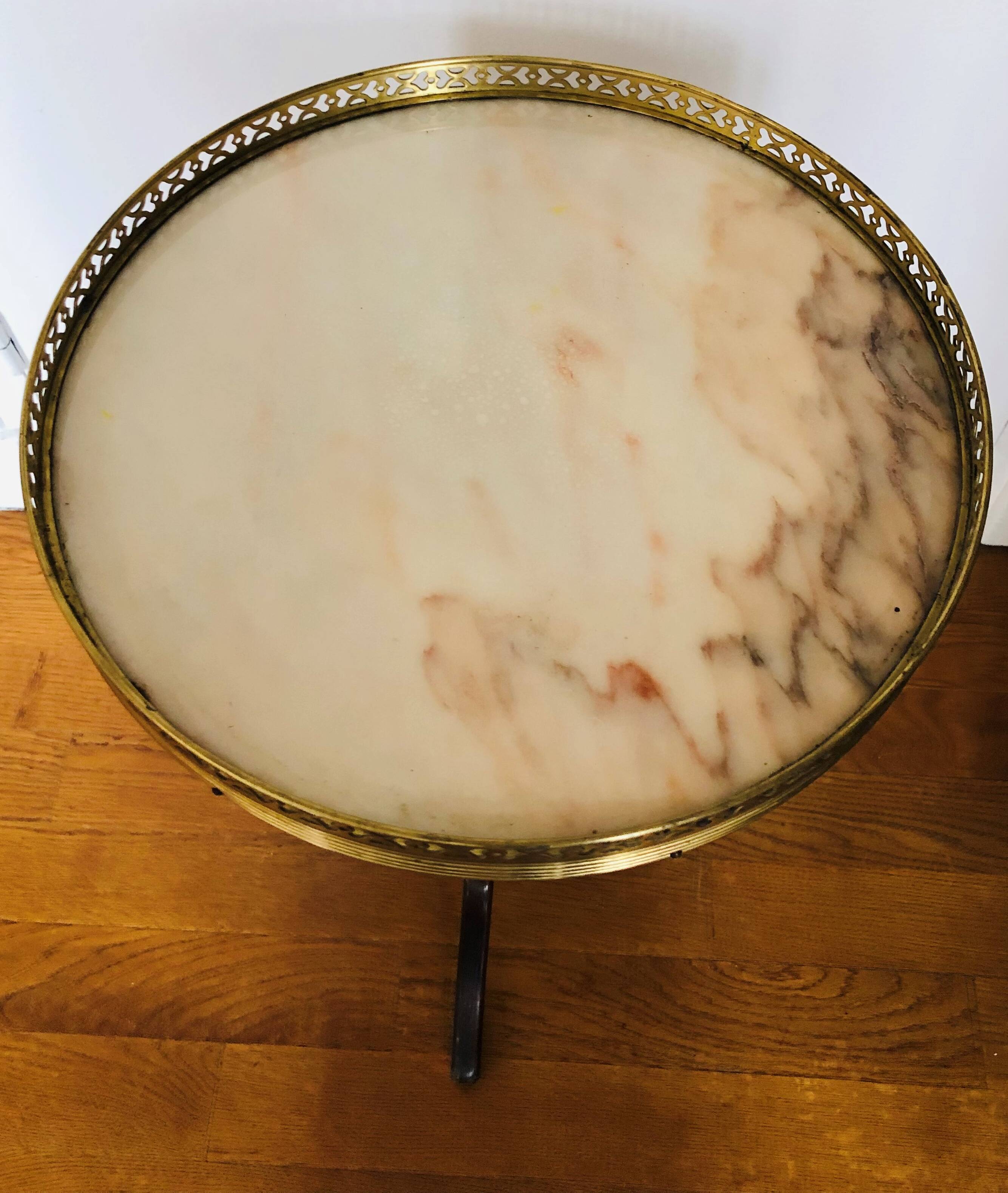 Wooden pedestal table on marble