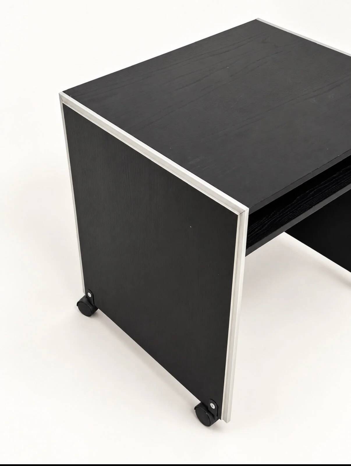 Vintage black computer desk on wheels with an aluminium edge.