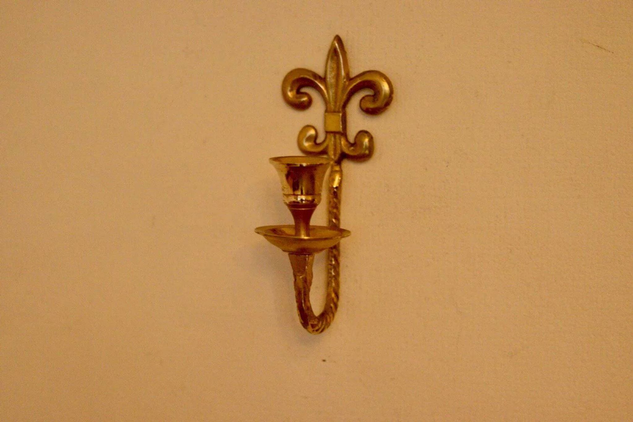 A pair of antique brass wall sconces.
